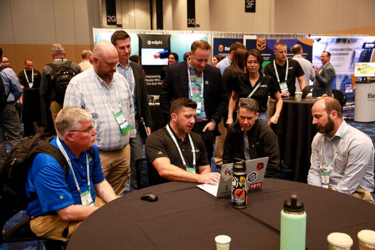 Construction professionals collaborating on project delivery solutions at an industry conference