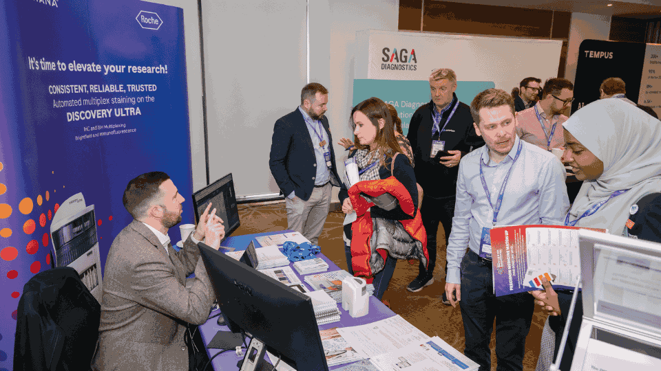 Construction professionals networking with exhibitors on project delivery solutions