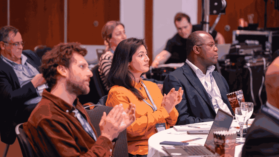 Conference attendees engaging in project delivery and construction innovation discussions