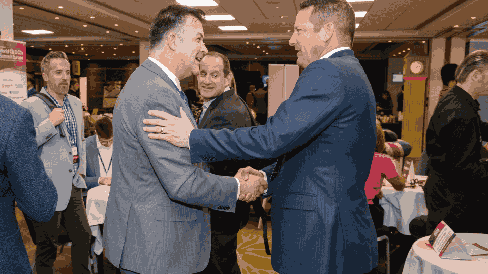 Construction leaders networking at a project delivery and innovation conference
