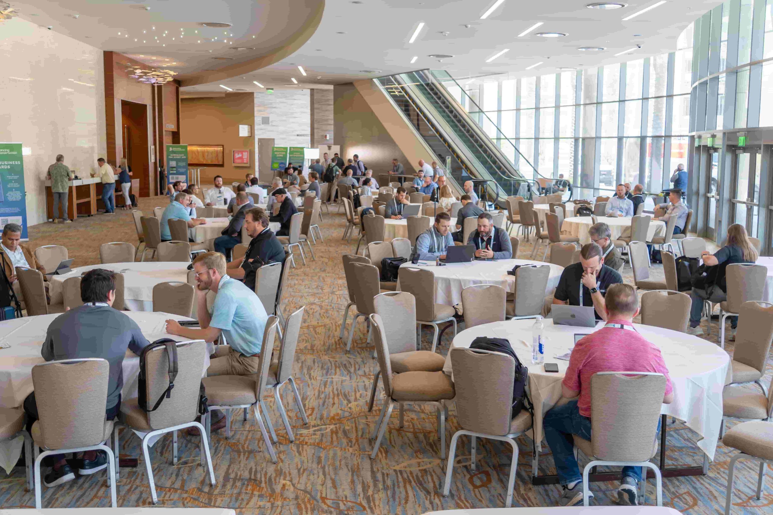 Construction professionals networking with exhibitors on project delivery solutions