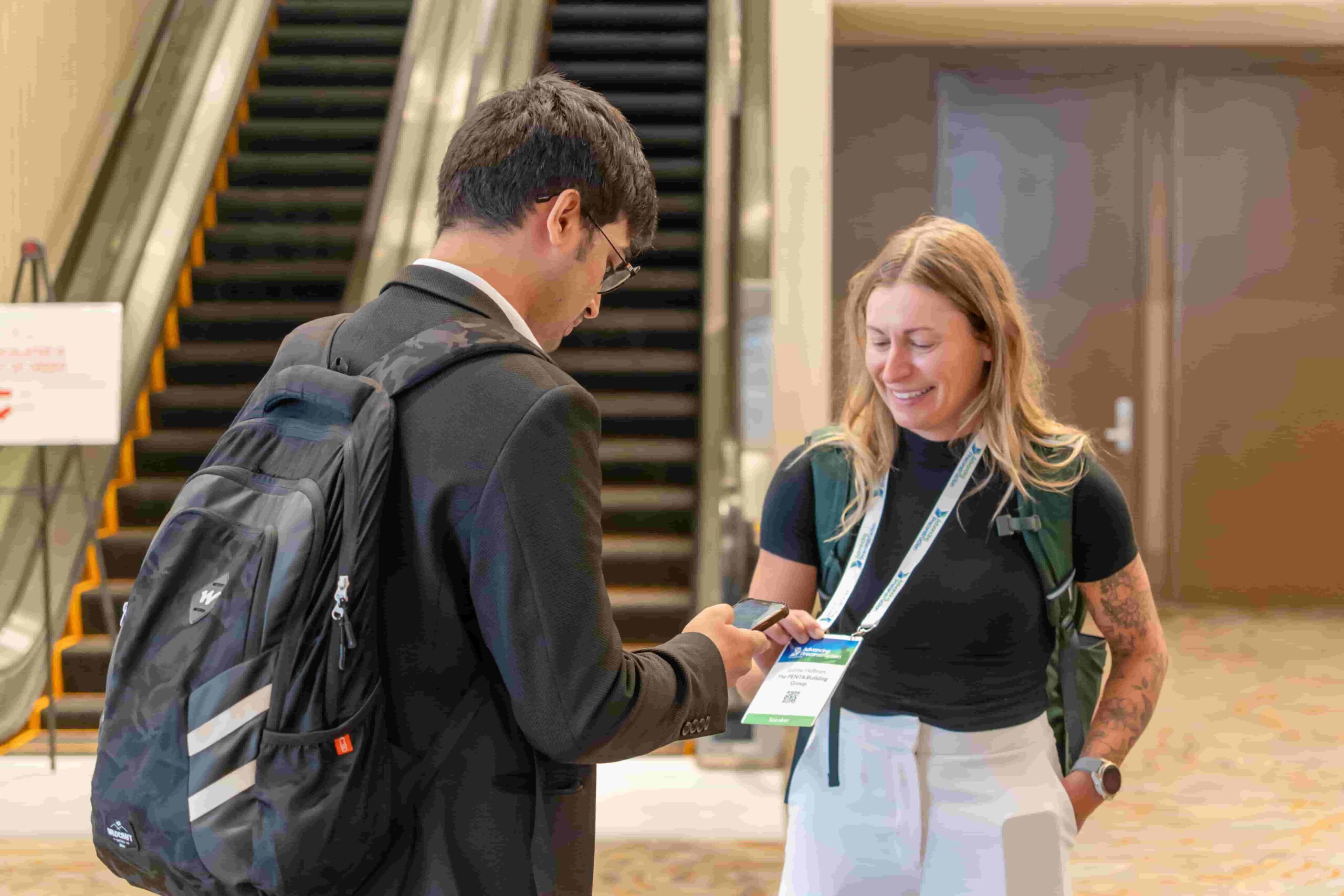 Construction professionals networking with exhibitors on project delivery solutions